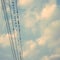 birds on power line cable against blue sky with clouds background vintage retro