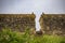 Birds sitting on either side of breach in ancient wall on overcast day - Wall that originally surrounded Oxford England