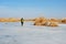 Birdwatcher walking on frozen wetland of Meyghan near Arak, Iran