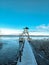 Birdwatching tower at the lakeside. Wooden pier that leads to a viewpoint.