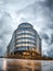 Birmingham Paradise Island new modern regeneration buildings from low angle with dramatic storm clouds and wet floor windows lit