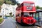 BIRMINGHAM, UK - March 2018 Red Double Decker Bus for Sightseeing Stationed beside Empty Waiting Shed. White Boutique