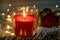 Birning red christmas candle with decorations at night, christmas eve mistery concept