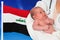 Birth rate in Iraq. Newborn baby in hands of doctor