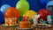 Birthday 12 cake on rustic wooden table with background of colorful balloons, gifts, plastic cups, plastic plate