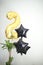 Birthday air ballons set up, gold number two and black shaped stars