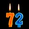 Birthday burning candles in the form of 72 seventy two for cake isolated on black background.