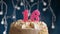 Birthday cake with 16 number pink burning candle on blue background. Candles blow out. Slow motion and close-up view