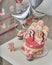 Birthday cake for 3 years decorated with butterflies gingerbread kitten with icing and the number three. meringue pale pink in the
