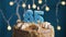 Birthday cake with 65 number candle on blue backgraund