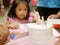 A birthday cake being cut / sliced to share it between guests