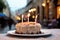 Birthday cake with burning candles on the background of the city, birthday cake with candle in street, outside party, AI Generated