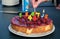 Birthday cake. Candles burn in the form of numbers 45. womans hand lighting the candles