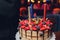 Birthday cake with candles. Candles on cake. Cake for holiday. Beautiful white cake with strawberries on dark background