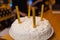 Birthday cake with candles. Candles on cake. Cake for holiday. Beautiful white cake with strawberries on dark background