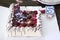 birthday cake with cream and strawberries and five years candle close up photo on the table