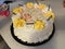 Birthday cake decorated yellow and white icing