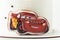 Birthday cake with gingerbread cookie in the shape of Lightning McQueen Car character of animated Pixar film series