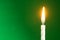 The birthday candle on a green background