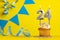 Birthday candle number 24 with cupcake - Yellow background with blue pennants
