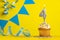 Birthday candle number 4 with cupcake - Yellow background with blue pennants