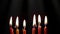 Birthday candles burning on dark background. Celebration party and anniversary concept.