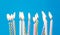 Birthday candles burning over blue background