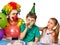 Birthday child clown eating cake with boy together. Kid with messy face.