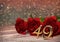 Birthday concept with red roses on wooden desk. forty-nineth. 39th. 3D render