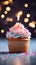 Birthday cupcake with burning candle, closeup, light background