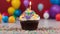 birthday cupcake with candle festive photo of a colorful birthday cupcake with candle on top