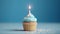 Birthday cupcake with a candle  on light blue background with balloons. Generative Ai