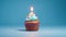 Birthday cupcake with a candle  on light blue background with balloons. Generative Ai