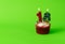 Birthday cupcake with polka dot and stripy candles showing eighteen against neon green background in landscape aspect