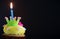 Birthday cupcake with a single blue candle.Cupcake with yellow cream and heart for love valentines.