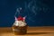 Birthday cupcake with two blown candles in cloud of smoke