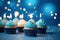 Birthday cupcakes with sparklers on blue background, closeup, Birthday cupcakes with candles on a blue background with confetti,