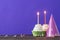 Birthday cupcakes on violet background