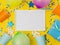 Birthday decorations with balloons, gift boxes, flowers, paper cups on a yellow background.