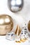 Birthday festive concept Silver gifts box and golden silver balloons with party hats