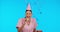Birthday, funny and balloons with a nurse woman in studio isolated on a blue background for celebration. Smile