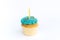 Birthday greeting concept. Yellow candle on muffin, cupcake. White background