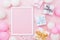 Birthday or holiday mockup with frame, gift box, pastel balloons and confetti on pink table top view. Flat lay composition.