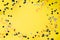 Birthday party background. Yellow table with confetti and ribbon. Place for text