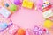 Birthday party banner or background with colorful balloons, carnival caps, gift boxes and confetti. Top view