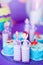 Birthday party concept. Table for kids with cupcakes with blue and red top and decored items in bright blue and purple colors.