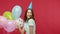 Birthday party. Happy joyful young brunette woman in t-shirt and cone hat waving