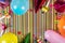 birthday party items on striped background with copy space