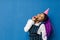 Birthday party, new year carnival. Young smiling African woman on blue background celebrating brightful event, wears