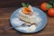 Birthday Party Piece of Homemade Cheescake with Tangerines on Gray Plate over Wooden Background. Top View.